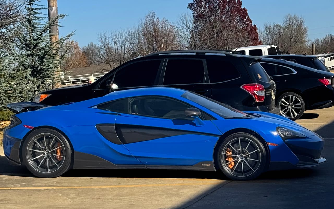 Blue McLaren parked outside Impact Auto Repair