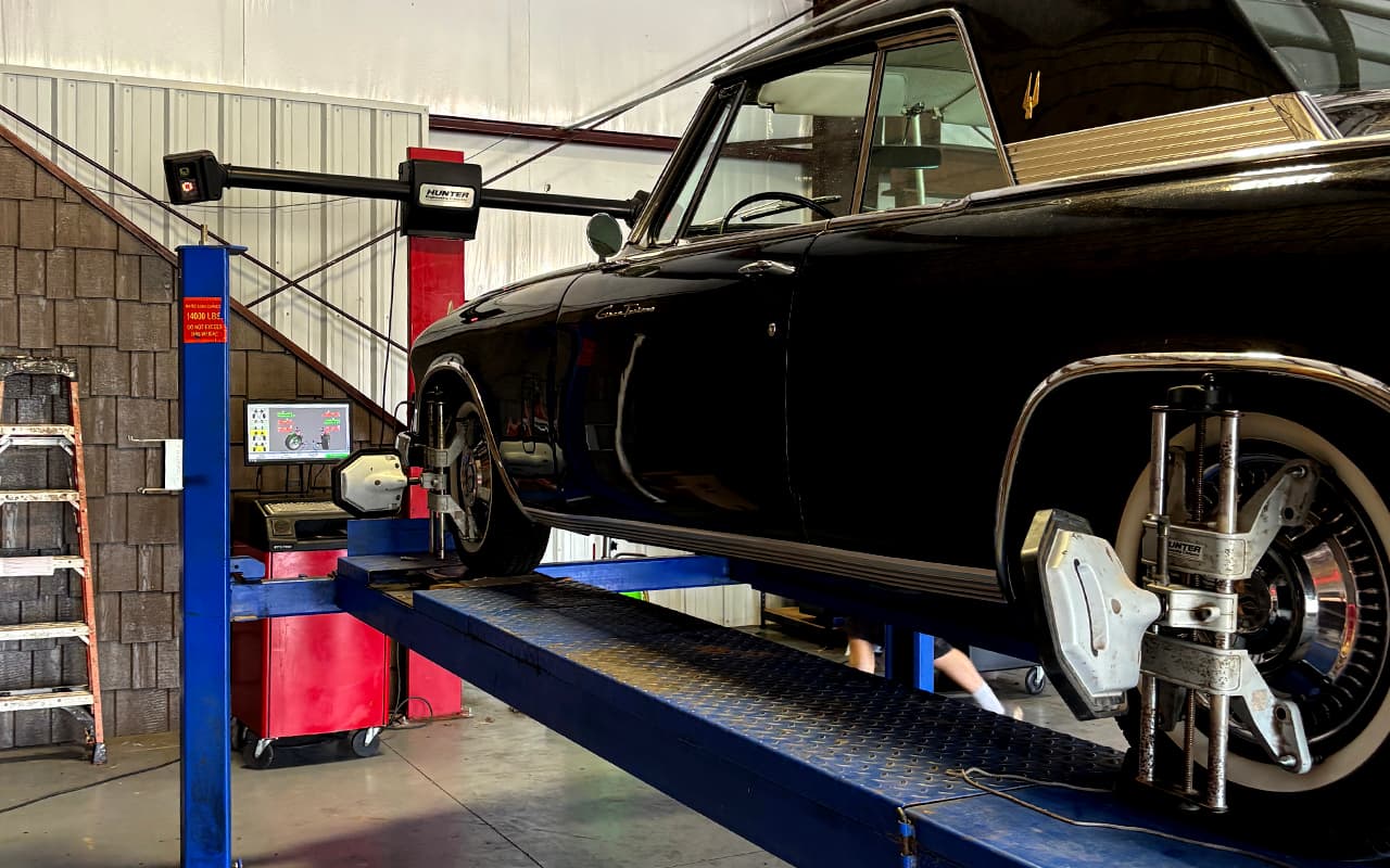 Classic vehicle raised on a lift for detailed service