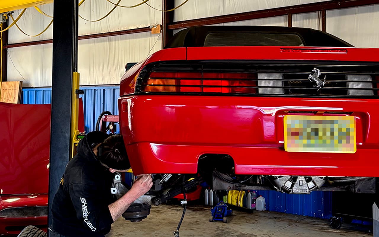 Technician working on a vehicle in the service bay