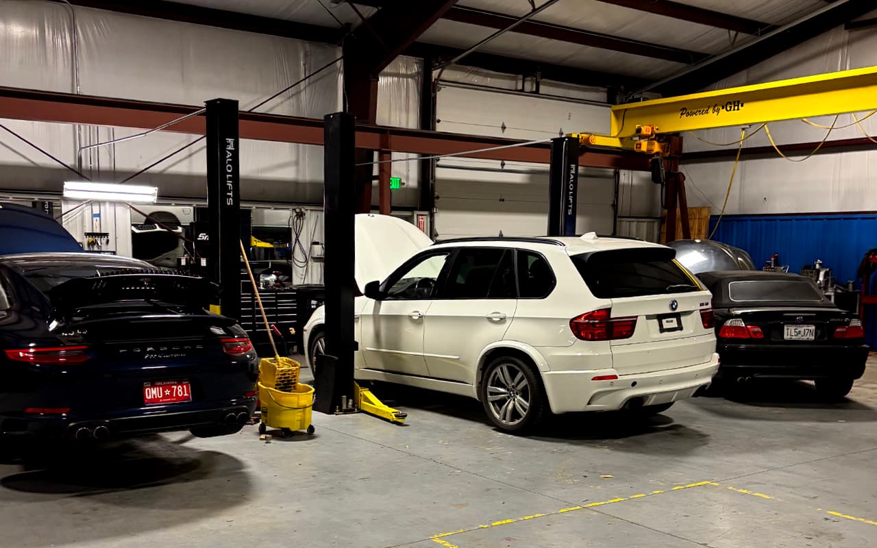 Impact Auto Repair shop floor with vehicles in service bays