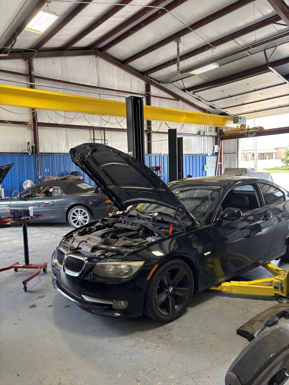 BMW with the hood open for cooling system service at Impact Auto Repair