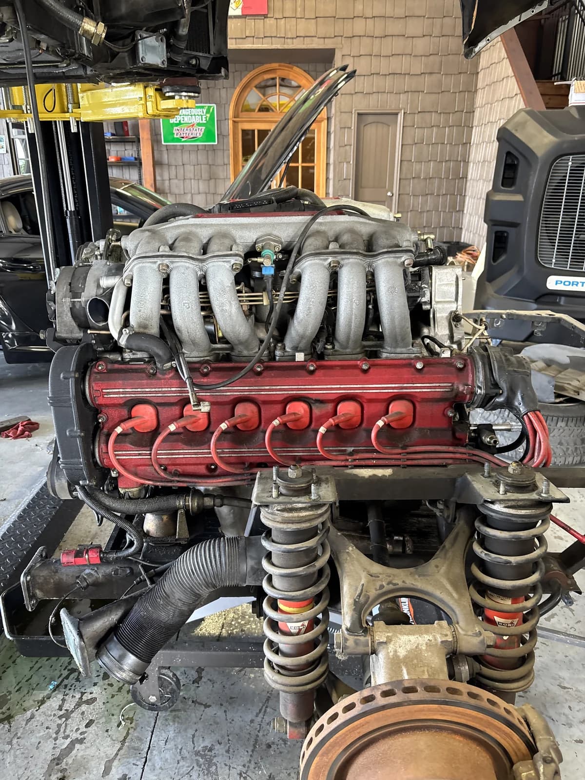 Exotic vehicle engine and suspension out for repair at Impact Auto Repair