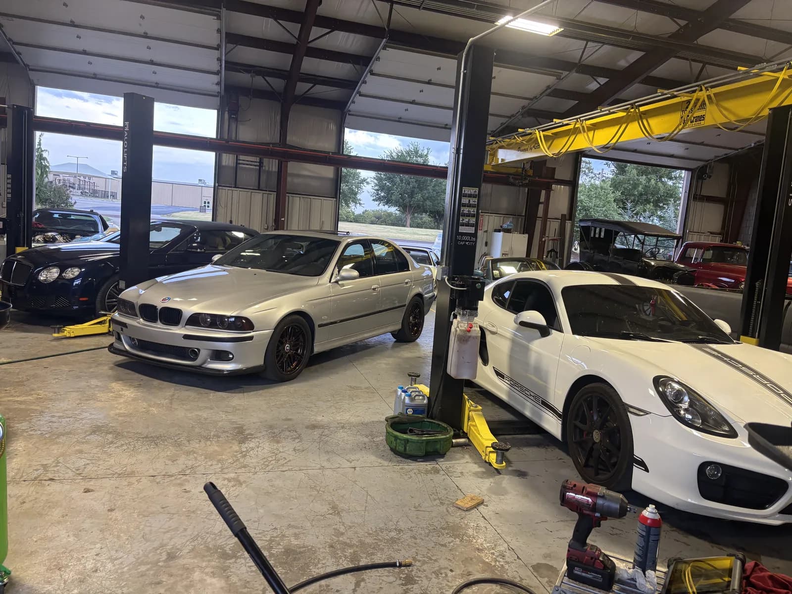 Vehicles in the service bay during inspection at Impact Auto Repair