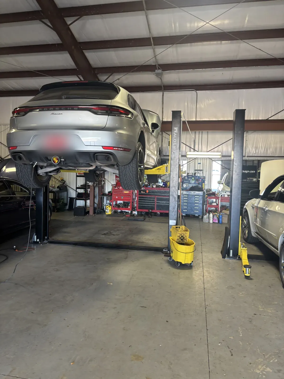 Vehicle raised on the rack for an alignment at Impact Auto Repair